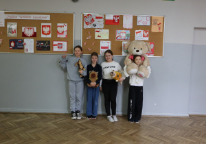 Grupa uczniów ze swoimi maskotkami.