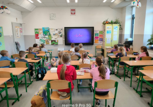 Uczniowie oglądający film w sali